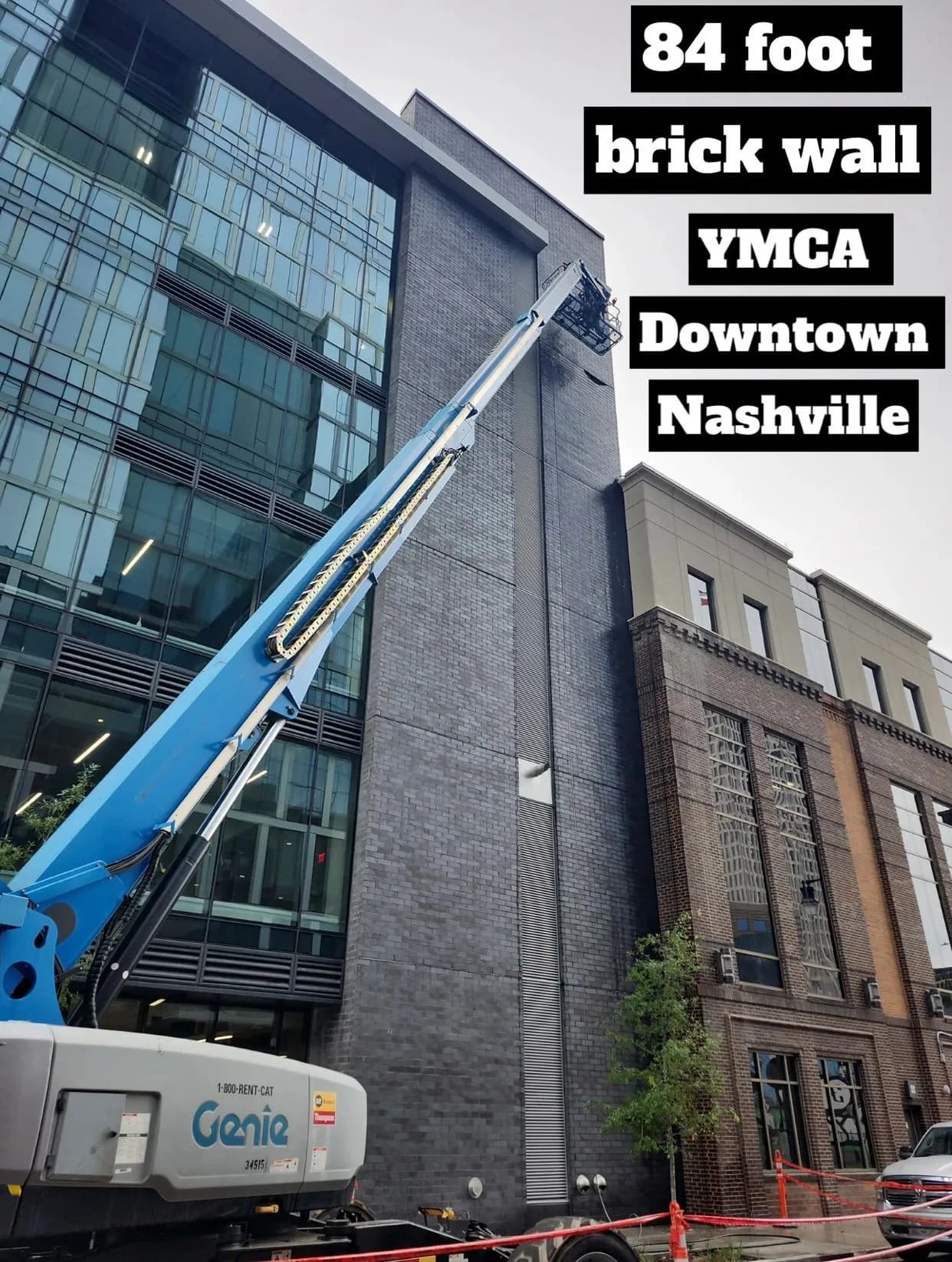 Boom lift extended against the 84 foot brick wall